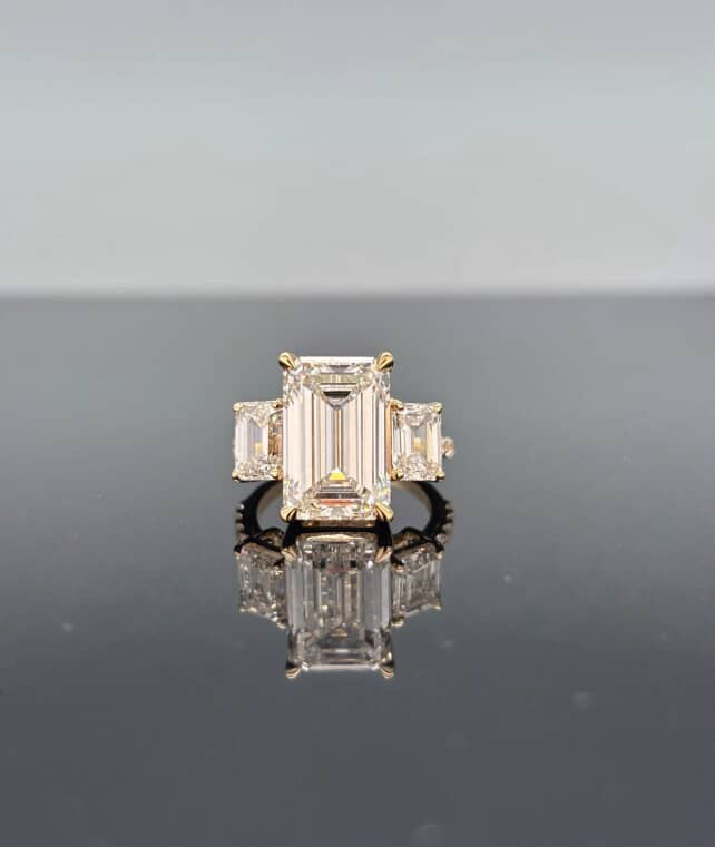 Three-stone emerald cut diamond ring