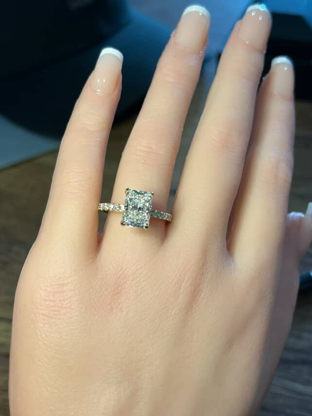 Radiant cut diamond ring with pavé band