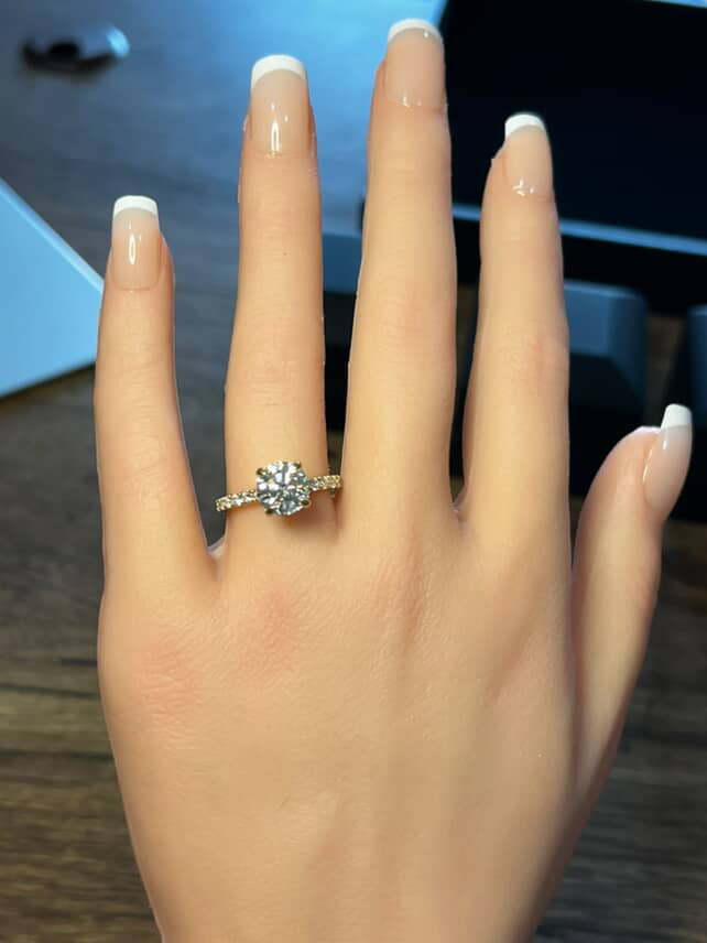 Round brilliant diamond ring with pavé band